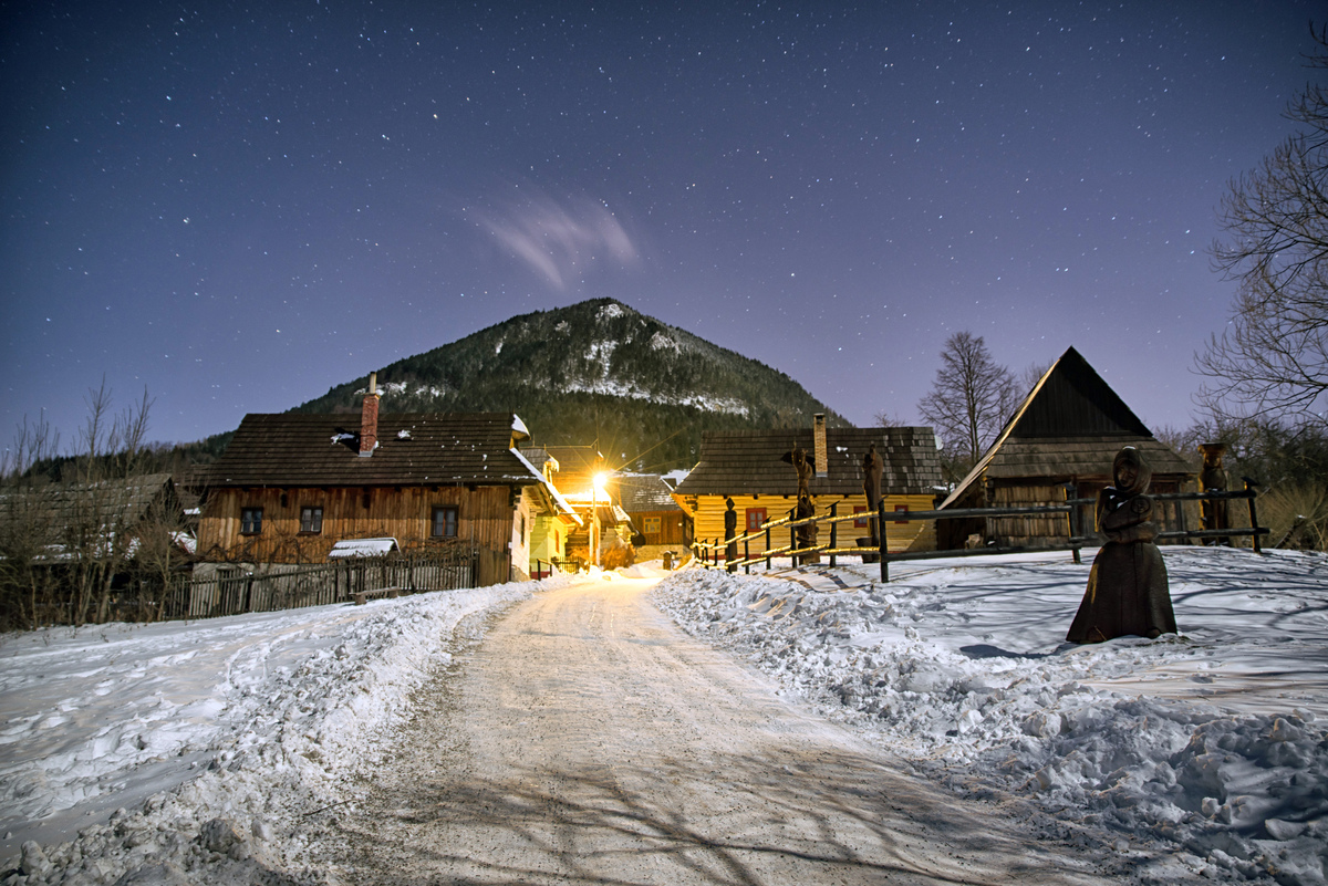 Wooden cottages in UNESCO rural village Vlkolinec at winter night, Slovakia